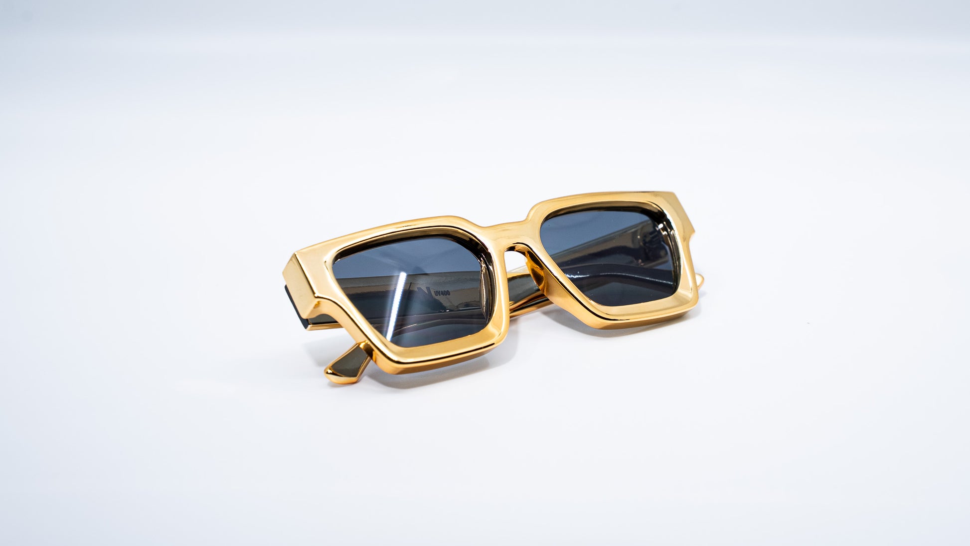 Ison Couture 24K Gold  square frame sunglasses folded on white background