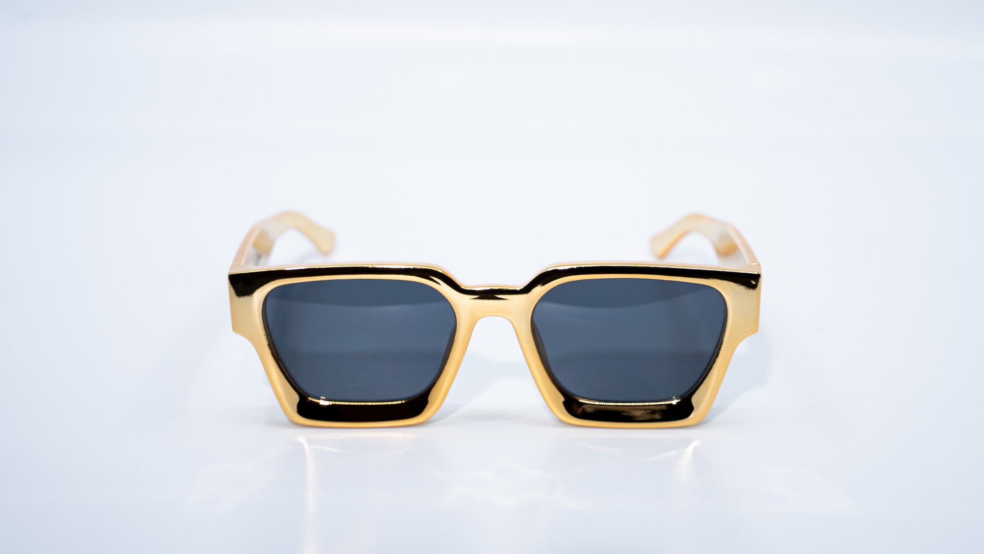 Ison Couture 24K Gold sunglasses front view showing gold frame and dark lenses
