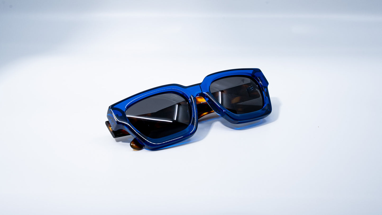 Ison Couture Blue Tortoise polarized sunglasses folded on white background