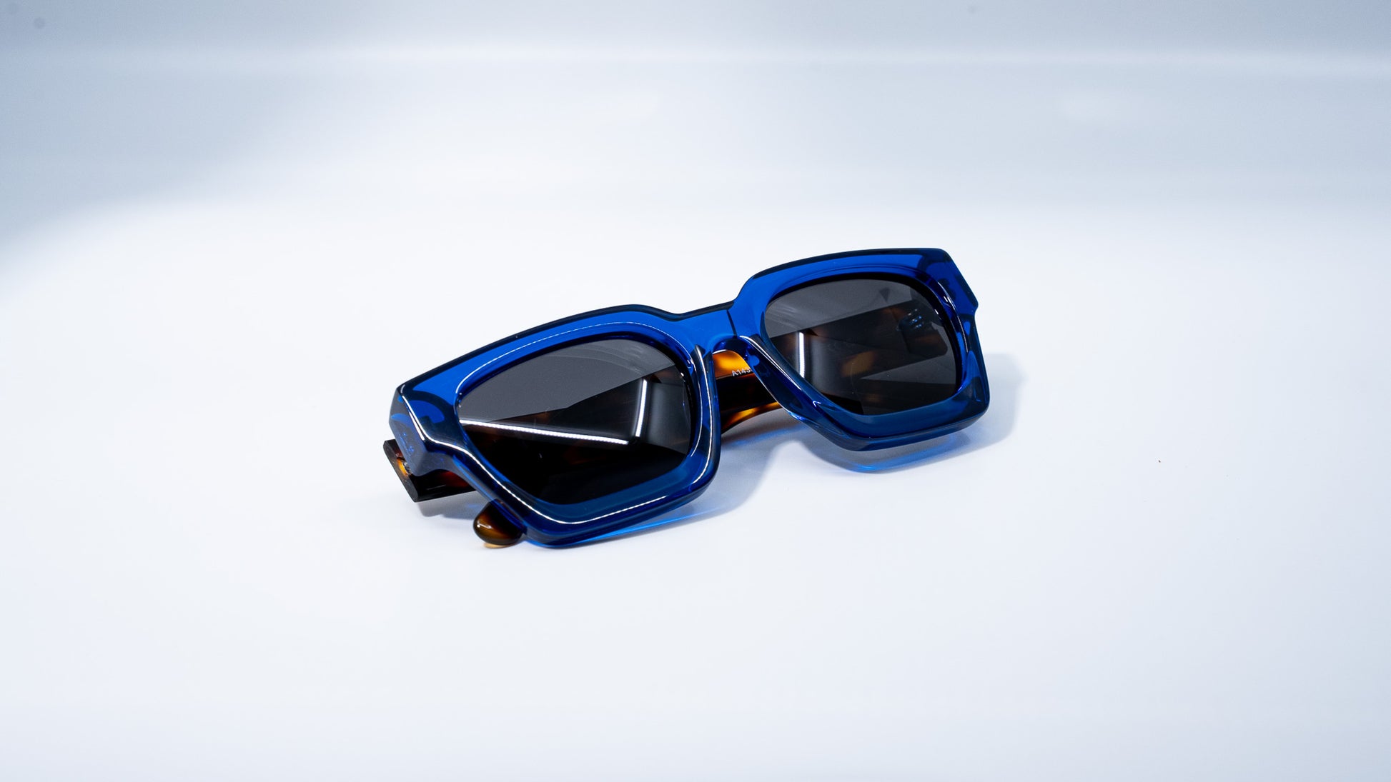 Ison Couture Blue Tortoise polarized sunglasses folded on white background