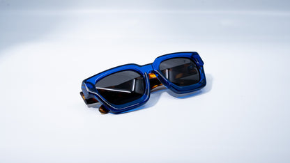 Ison Couture Blue Tortoise polarized sunglasses folded on white background