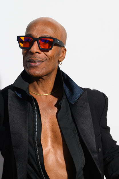 African American male wearing blue light blocking glasses by Ison Couture in a studio