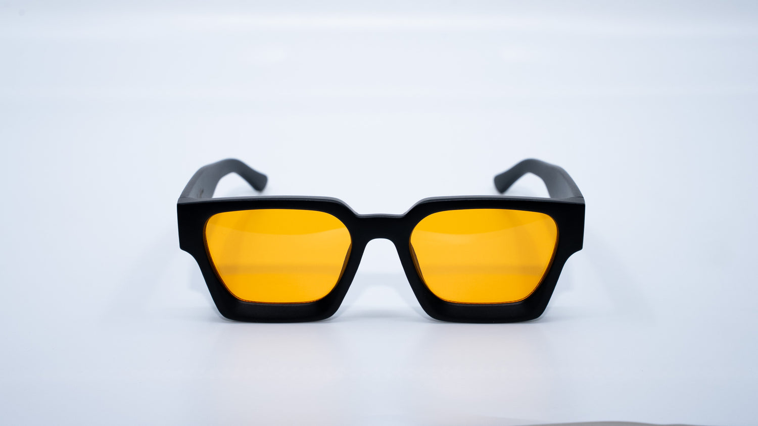 Ison Couture Matte Golden Hour square sunglasses with golden orange lenses side angle