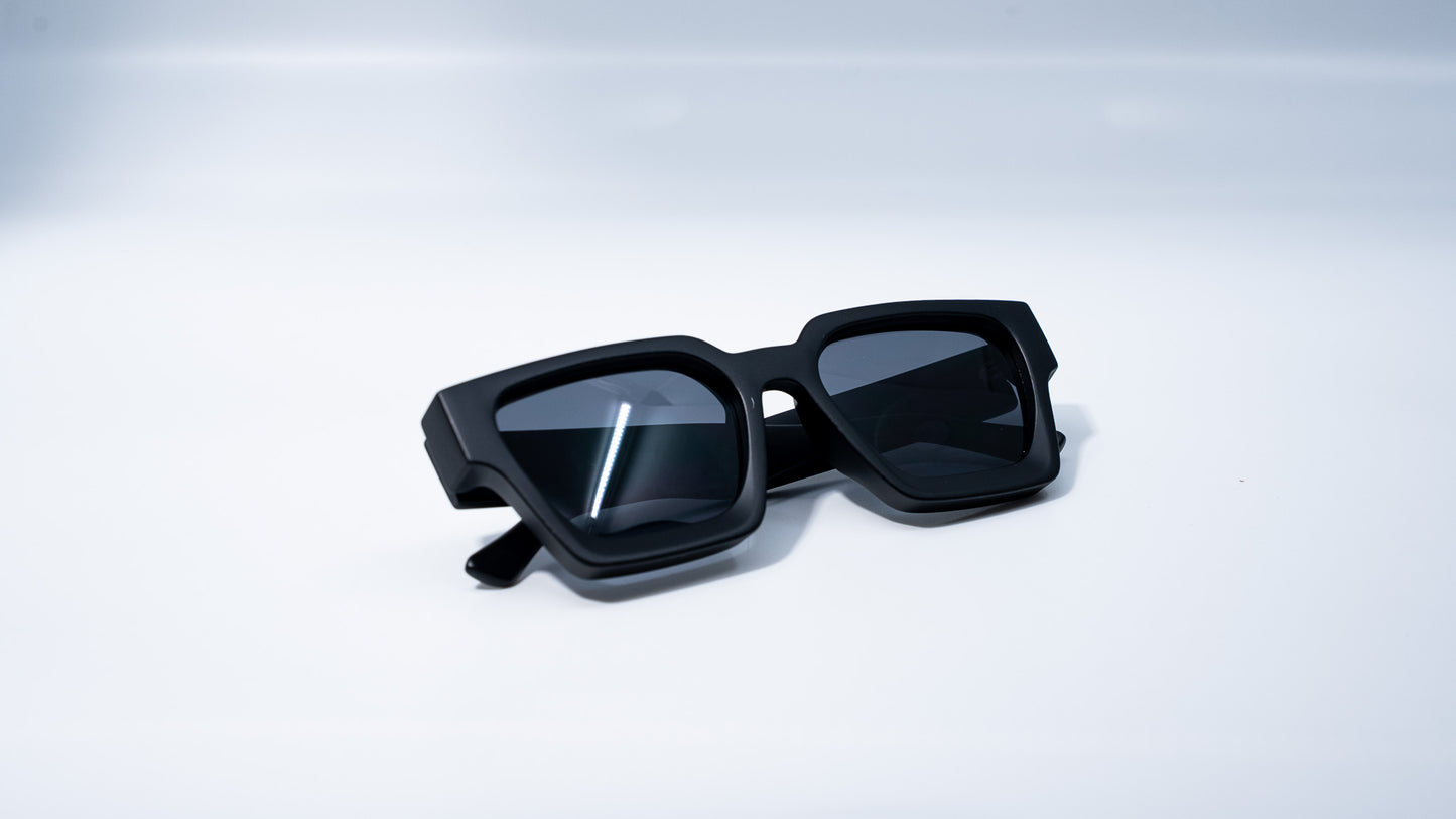 Ison Couture Matte Black sunglasses folded on white background