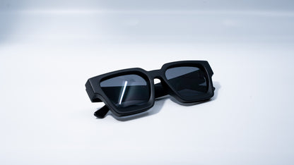Ison Couture Matte Black sunglasses folded on white background