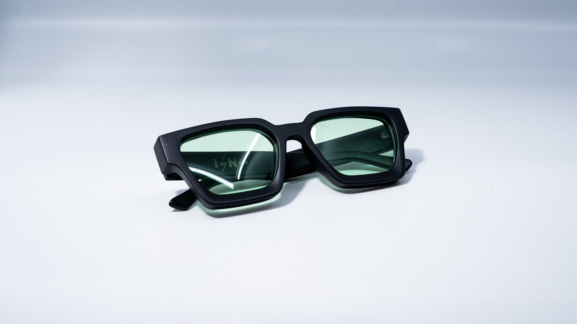 Ison Couture Matte Mint sunglasses folded on white background