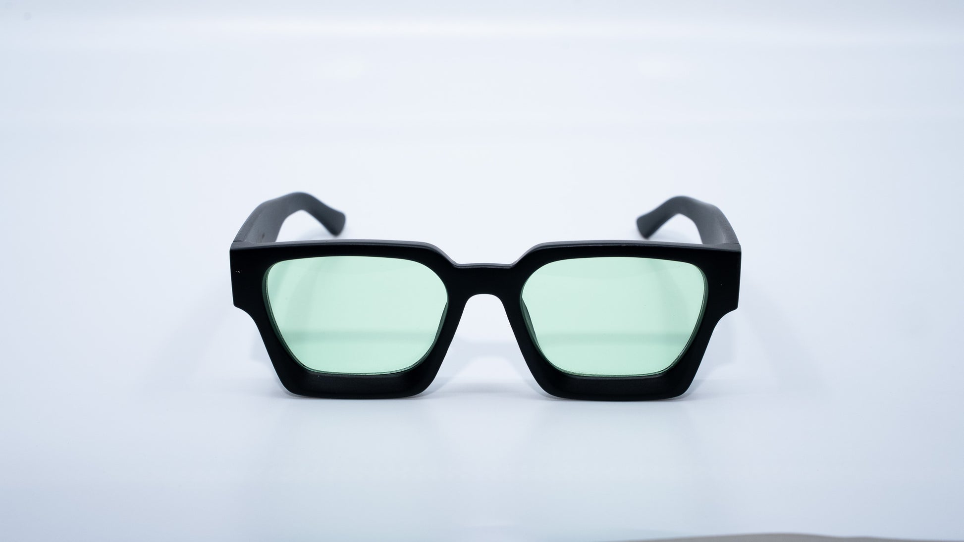 Ison Couture Matte Mint sunglasses front view showing matte black frame and minty green lenses
