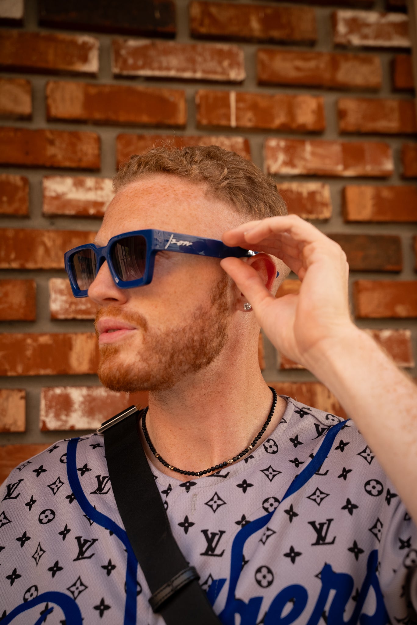 Man wearing Ison Couture Royal Blue bold square sunglasses with gradient lenses