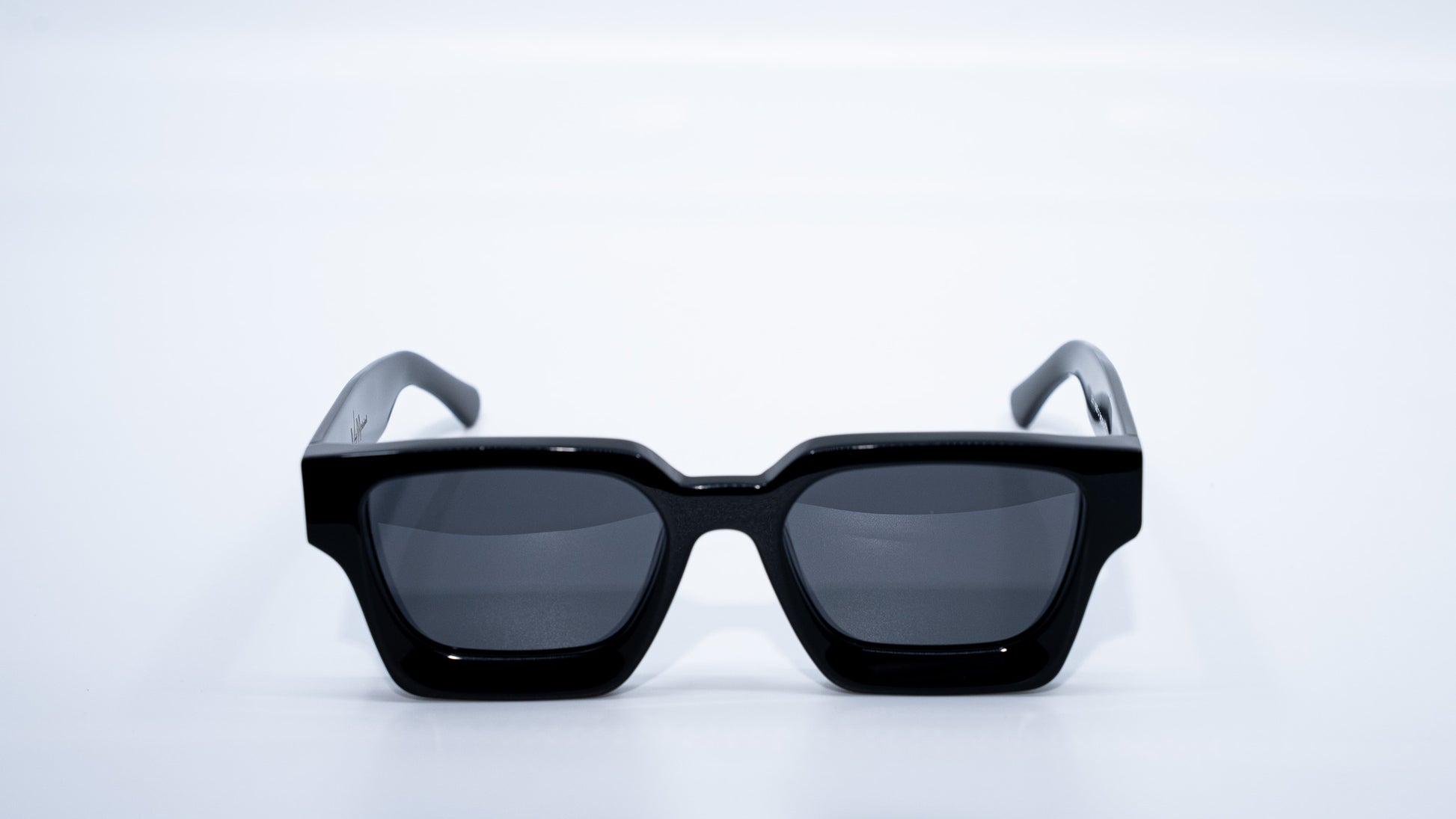 Ison Couture Polar Black polarized sunglasses front view showing bold all-black frame