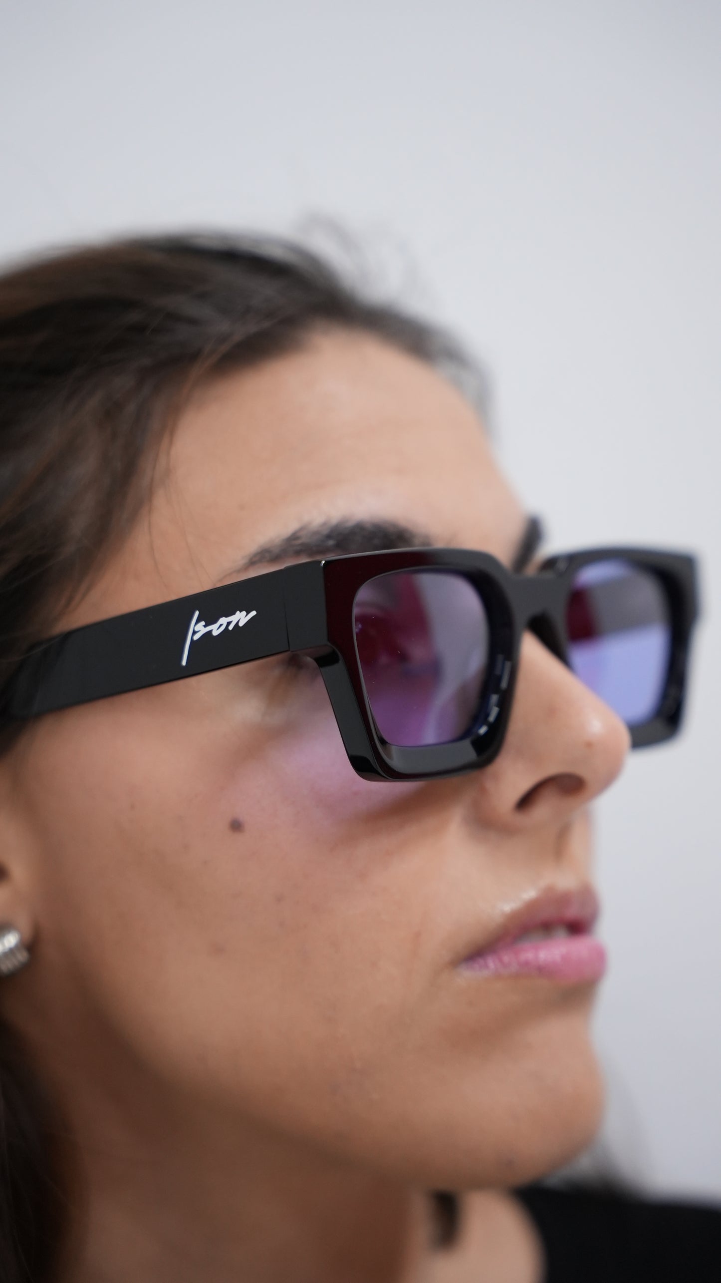 Woman wearing Ison Couture Purple Haze bold square sunglasses with purple polarized lenses