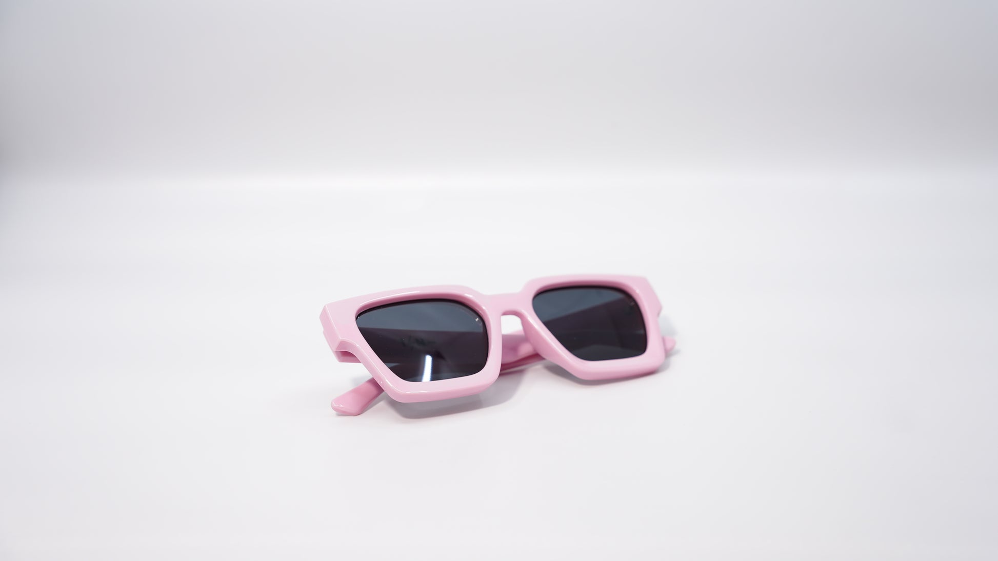 Ison Couture Soft barbie Pink sunglasses folded on white background
