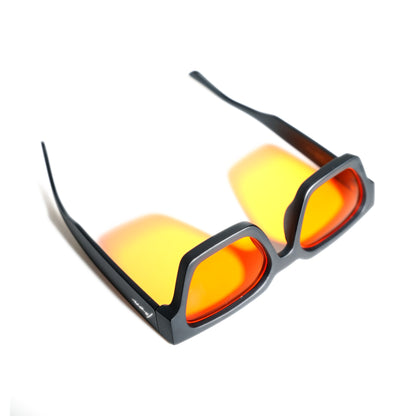 AfterBurner orange lens blue light glasses seen from above with temples open, matte black square frame
