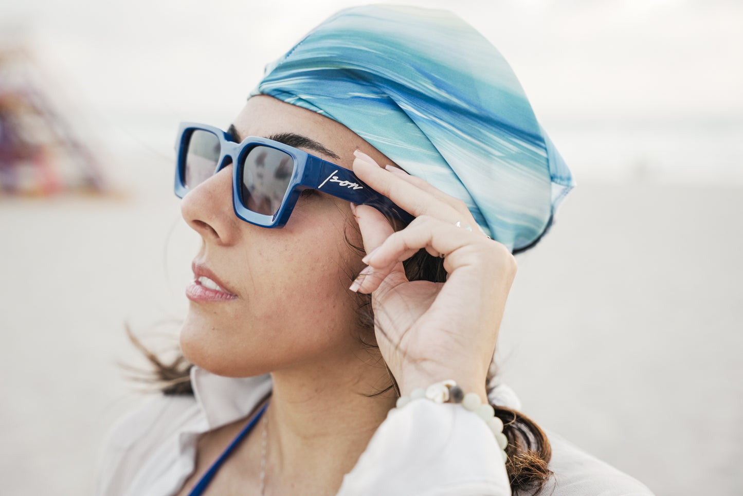 Woman wearing Ison Couture Royal Blue bold square sunglasses with gradient lenses