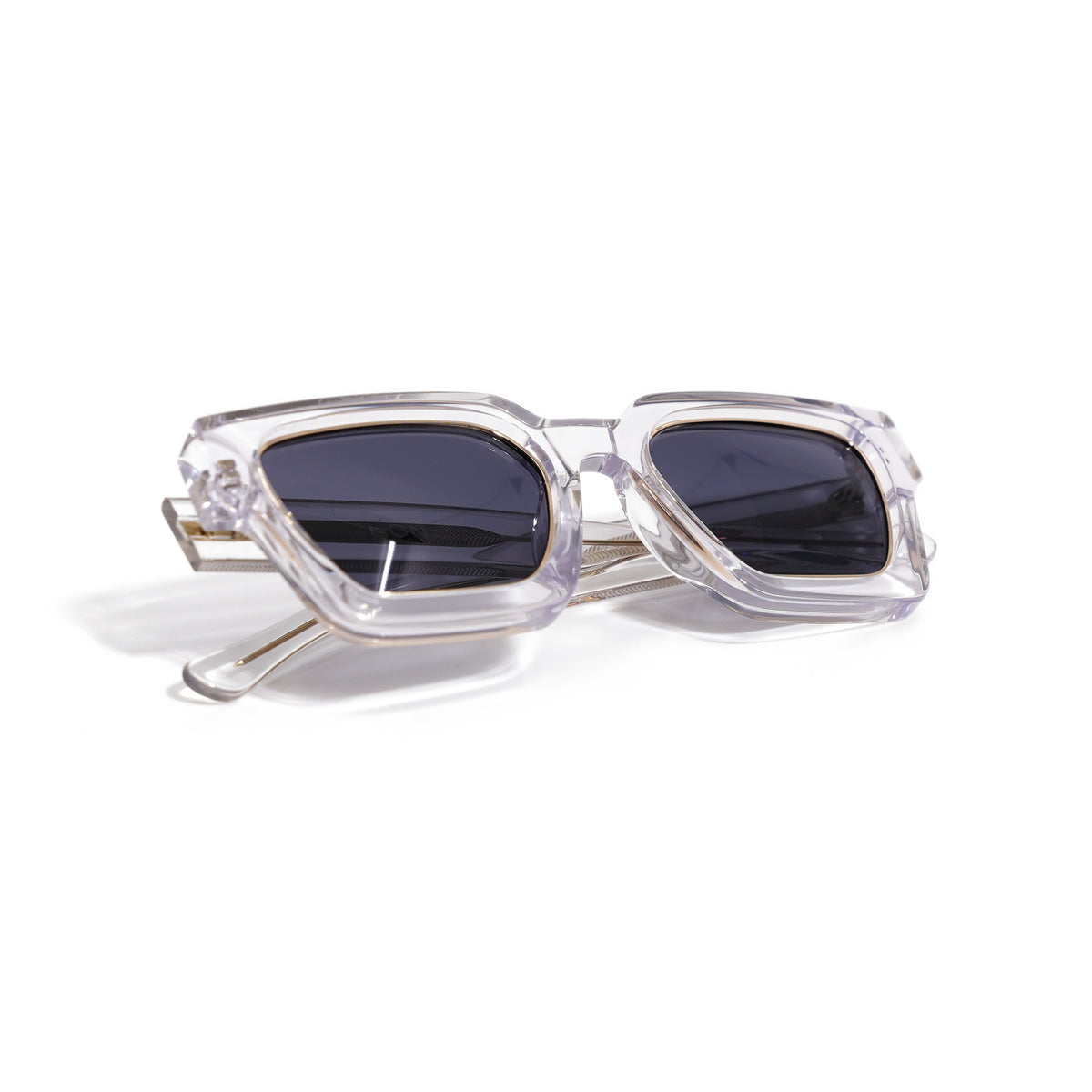 Crystal Clear & Gold sunglasses folded, showing the gold core rods through the transparent temples