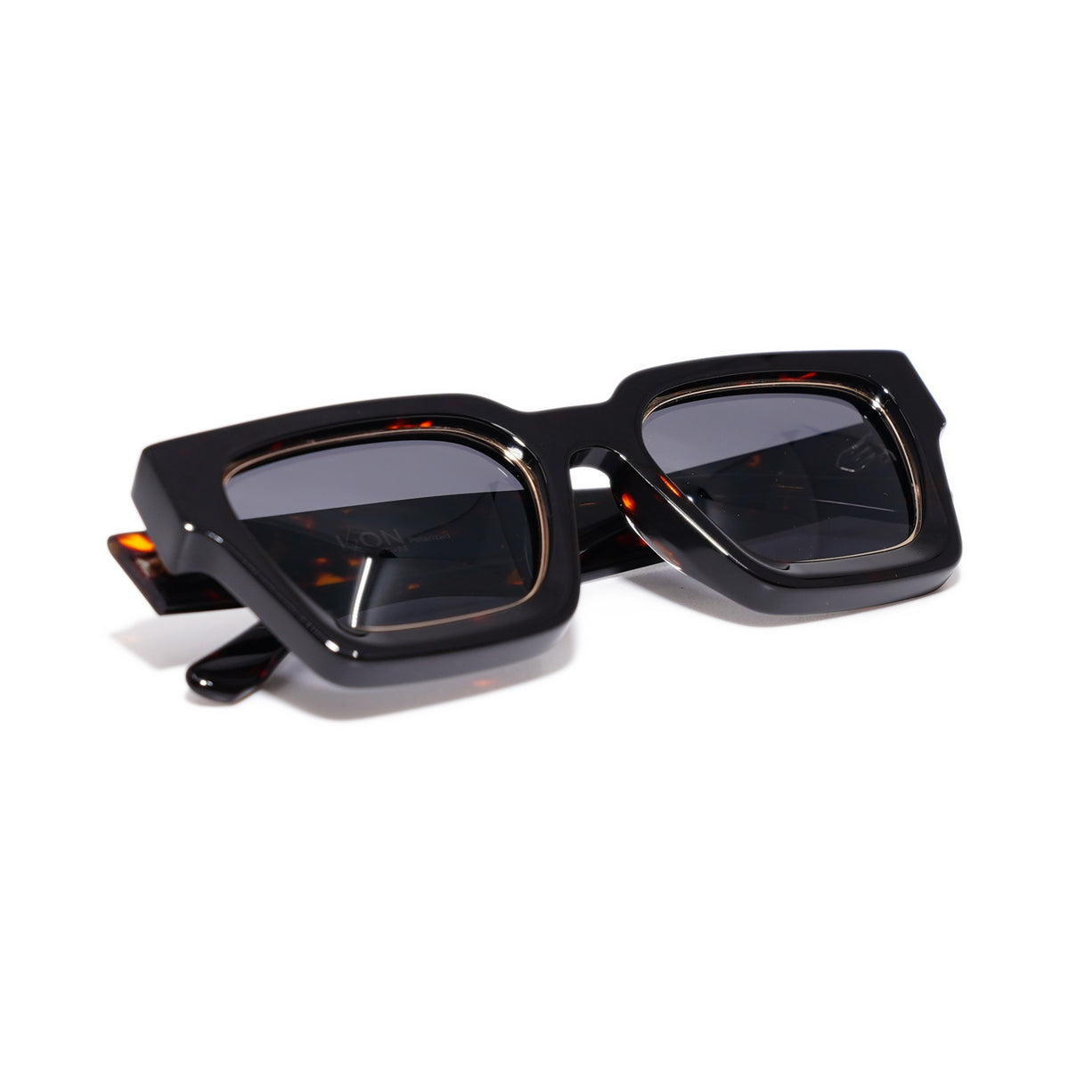 Dark Tortoise sunglasses folded, showing the gold-lined lens rims and dark tortoise acetate