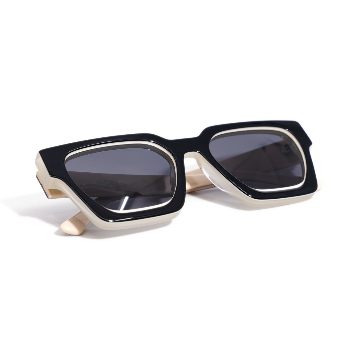 Fusion Calico sunglasses folded, showing the black and frosted ivory layered bio-acetate edges