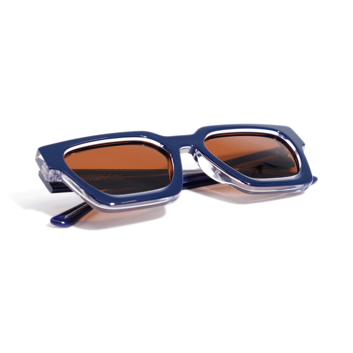 Fusion Navy Crystal sunglasses folded, showing the navy and crystal clear layered acetate edges
