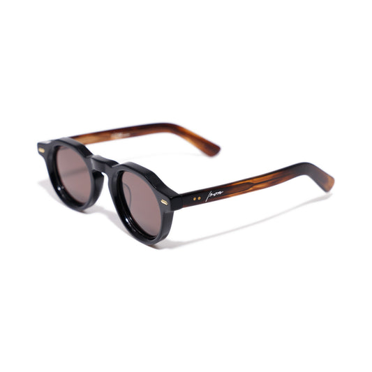 Ison Couture Round & Brown polarized sunglasses, gloss black front with striated amber temples, three-quarter view