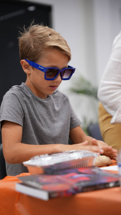 Kid wearing Ison Couture Royal Blue bold square sunglasses with gradient lenses