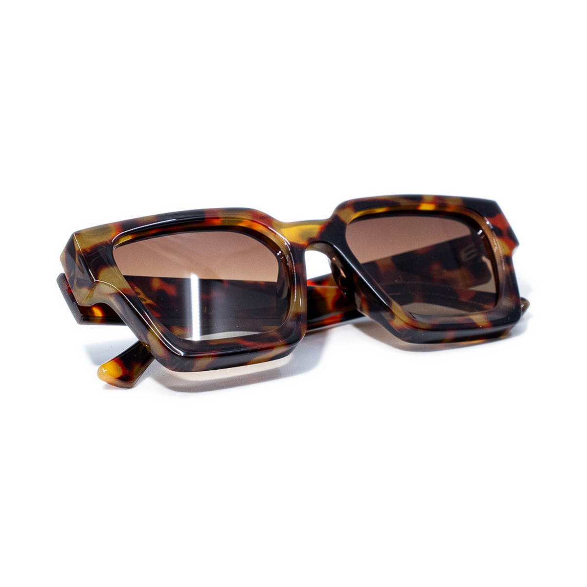 Tigers Eye sunglasses folded, warm amber and chocolate tortoise frame with brown gradient lenses